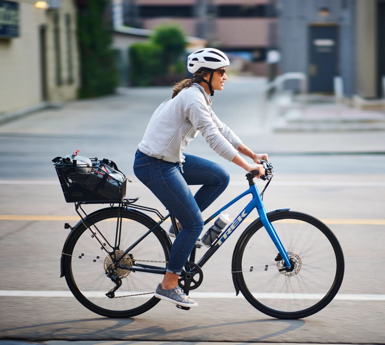 Woman riding a hybrid city bike in an urban location 